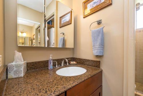 a bathroom with a sink and a mirror at Kealia Resort 309 in Kihei