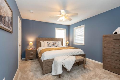 a bedroom with a bed and a ceiling fan at Hoosier Happiness, Too! 3 Bedroom Suites Near IU & Downtown in Bloomington