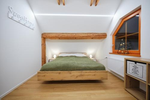 a bedroom with a bed and a window at Mia Bella luxury chalet in Slovenske Konjice in Slovenske Konjice