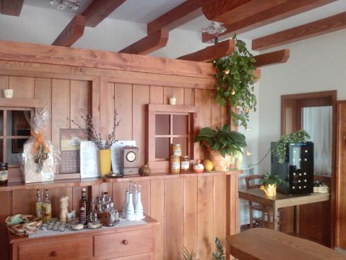 a kitchen with a wooden cabinet with a clock on it at Osterija Na Planinci in Divača
