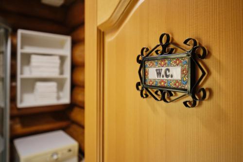 a clock on a wall next to a refrigerator at Mia Bella luxury chalet in Slovenske Konjice in Slovenske Konjice