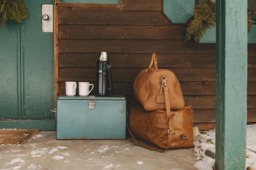a brown backpack sitting next to a wooden wall at Anchor Inn in Traverse City