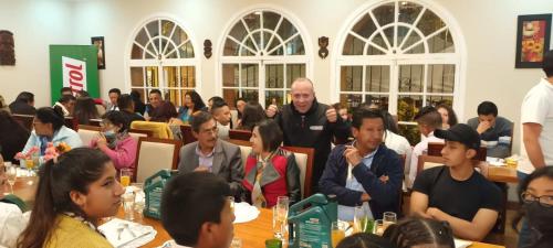 a group of people sitting at tables in a room at Hotel Boutique Spa Villa de Sant in Quito