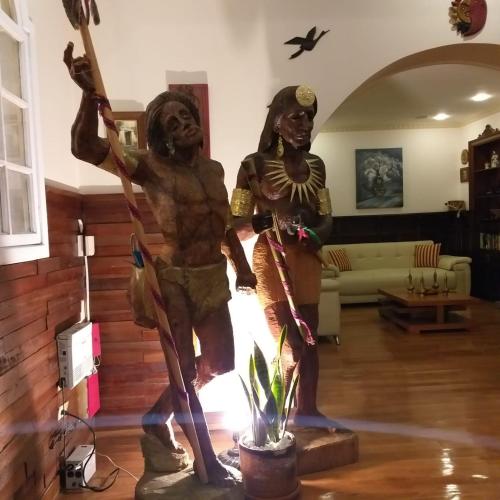 two statues of two men standing in a living room at Hotel Boutique Spa Villa de Sant in Quito