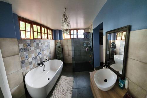 a bathroom with a tub and a sink and a toilet at Melvilla House in Johannesburg