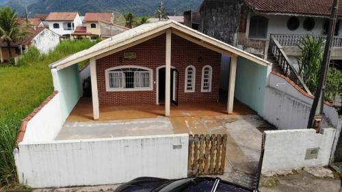 een stenen huis met een veranda en een garage bij Casa no Guaraú - Peruíbe in Peruíbe