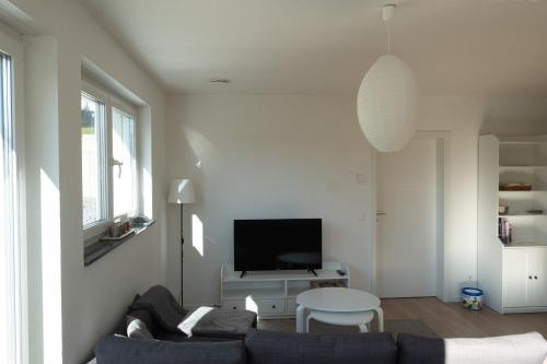 a living room with a couch and a tv at Top Wohnung mit traumhaftem Fernblick in 1A-Lage! in Hagen
