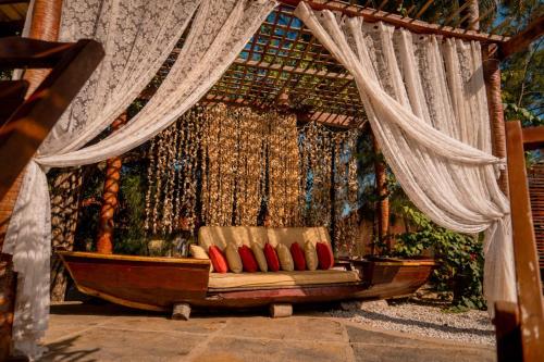 a couch in front of a stage with curtains at Pousada Morada do Sol in Camocim