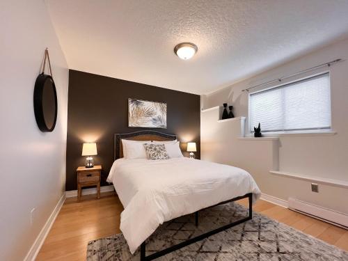 a bedroom with a large bed and a window at The Royal Bay Getaway in Victoria