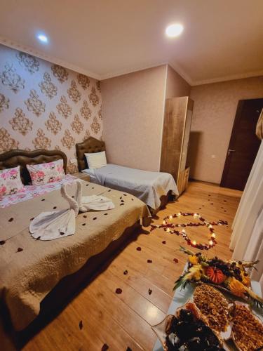 a bedroom with two beds and a wooden floor at Hotel Lotus in Akhaltsikhe