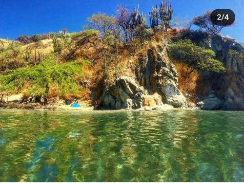 a view from the water of a rocky island at Taganga Dive Inn in Taganga