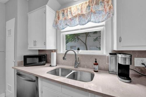a kitchen counter with a sink and a window at High Point Terrace Bungalow in Memphis