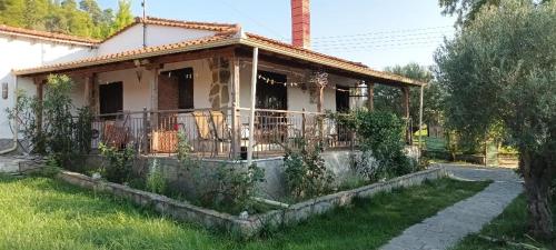 a small house with a balcony in a yard at Alex house with garden in kallithea halkidiki in Kallithea Halkidikis