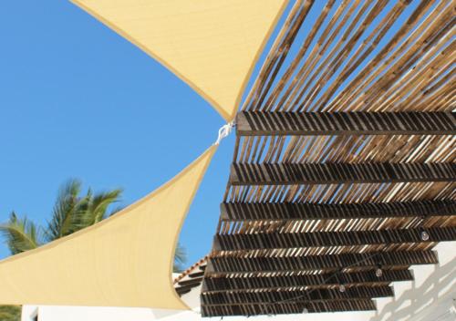 a close up of a straw umbrella on a beach at Puerto Bianco Private Residence Collection in Copala