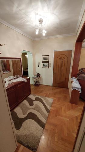 a living room with a bed and a rug at Το Σπιτικό της Μαρίας in Maniákoi