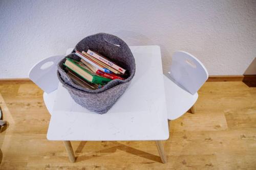 a white table with a bag of pencils on it at Ferienhaus Regenstein in Winterberg