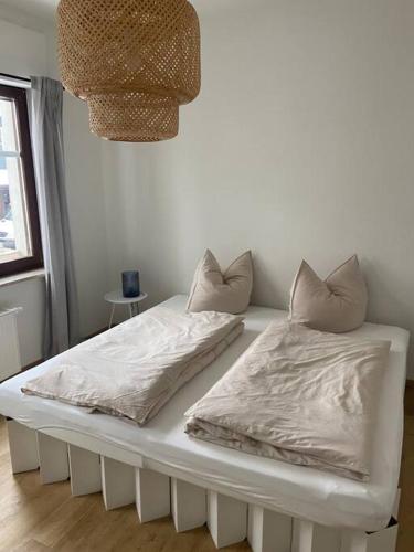 a white bed with two pillows on top of it at Ferienhaus Regenstein in Winterberg