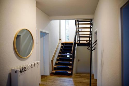 a hallway with a spiral staircase with a mirror at Ferienhaus Regenstein in Winterberg