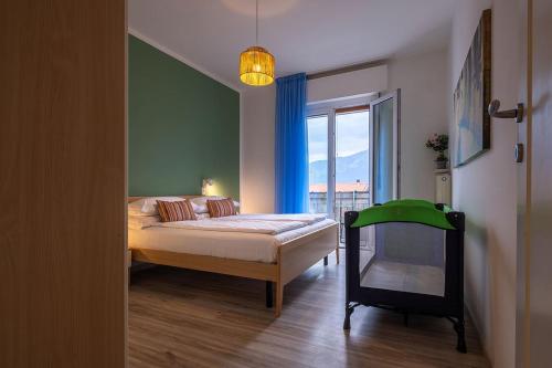 a bedroom with a bed and a large window at Lake view with Aircon - 5 minutes from the beach! in Brenzone sul Garda
