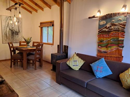 a living room with a couch and a table at Cabañas Los Volcanes Ensenada Puerto Varas in La Ensenada