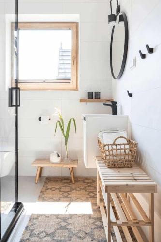 a bathroom with a bench and a window at Domki Górski & Polny Kwiat in Zakopane