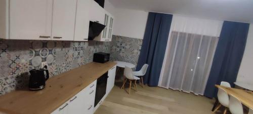 a kitchen with a counter and some white cabinets at Villa U Skupniów Suche-Zakopane in Poronin