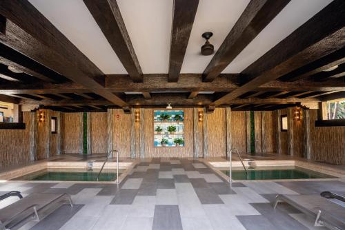 a pool in a room with wooden walls at Riu Santa Fe - All Inclusive in Cabo San Lucas