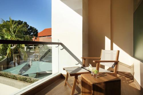 a room with a chair and a table on a balcony at The Westin Resort Nusa Dua, Bali in Nusa Dua