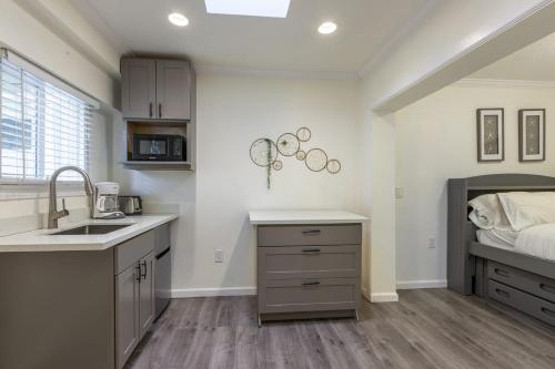 a kitchen with a sink and a bed at @ Marbella Lane - Adorable and Quiet Studio in San Mateo