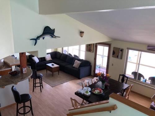 a living room with a couch and a table at Beautiful Ocean Front Coastal Sunset Beach House in Oxnard