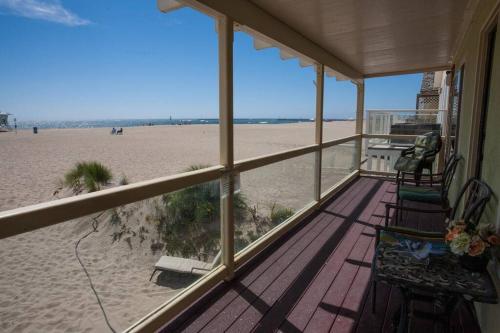 a view of the beach from the porch of a beach house at Beautiful Ocean Front Coastal Sunset Beach House in Oxnard