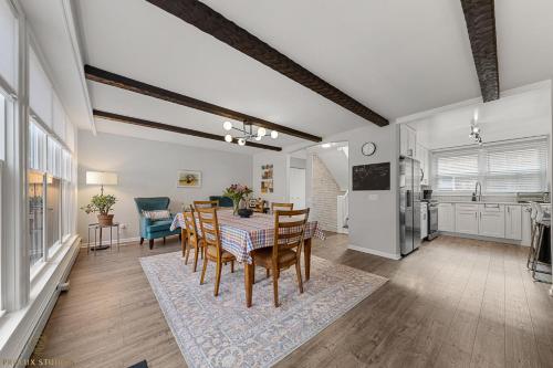 a dining room and kitchen with a table and chairs at Northside FAMLYNEST Lincoln Sq 4BR 2BA 2P Rare find in Chicago