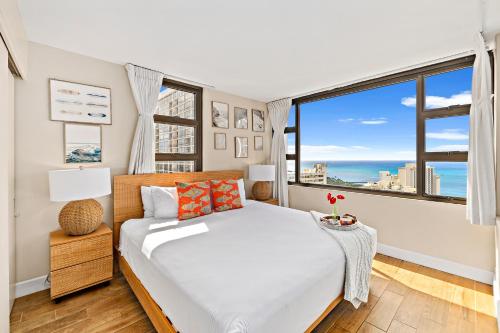 a bedroom with a bed and a large window at 30FL Great Ocean Views with Lanai, King bed, Parking in Honolulu