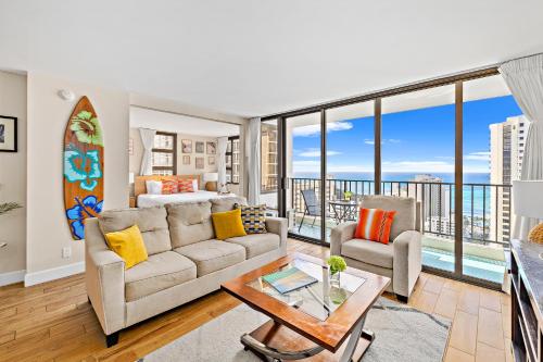 a living room with a couch and a table at 30FL Great Ocean Views with Lanai, King bed, Parking in Honolulu