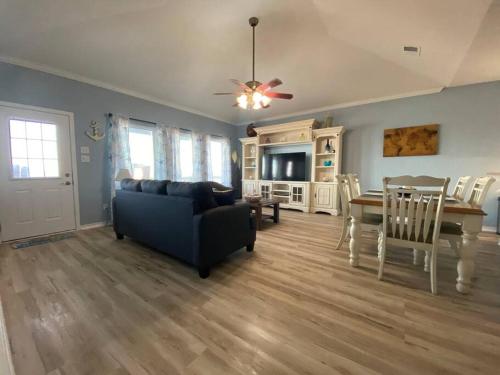 a living room with a couch and a dining room at Beach House with Ocean view in Surfside Beach
