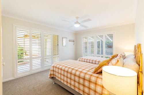 a bedroom with two beds and a window at Anchored at Fingal Bay 80 Marine Drive in Fingal Bay