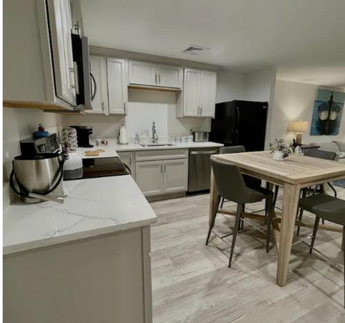 a large kitchen with a table and chairs in it at Harbourtown Suite Water View in Plymouth