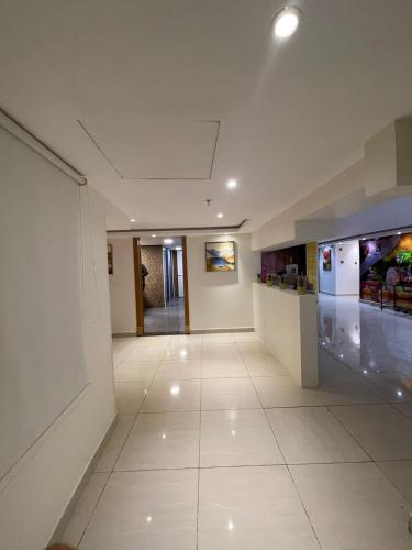 an empty hallway in a building with a white floor at Mira Business Hotel in Riyadh