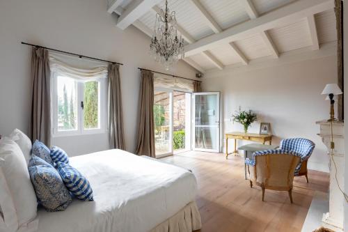 Un dormitorio con una cama y una lámpara de araña. en Lalisea, en Talaveruela