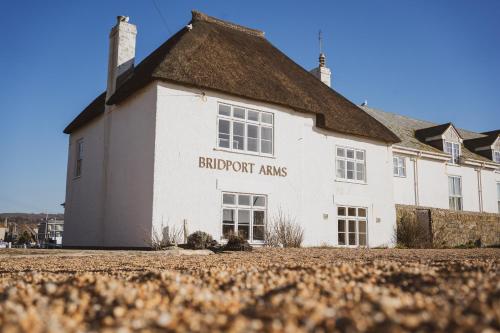 a white building with the wordsbridgart arms on it at Bridport Arms Hotel in West Bay