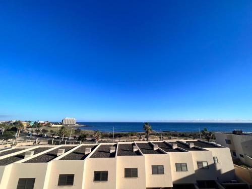 a view of the beach from the roof of a building at Seafront Medano Marina View in El Médano