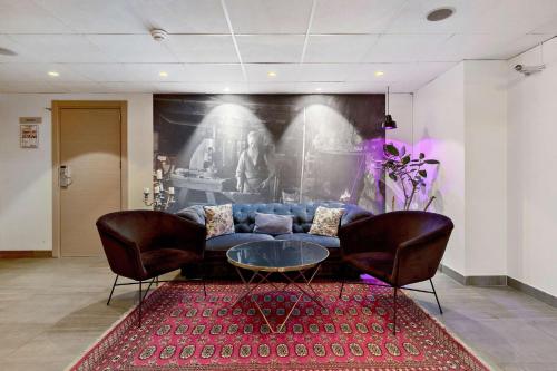 a living room with a couch and two chairs at Best Western Plaza Hotel in Eskilstuna