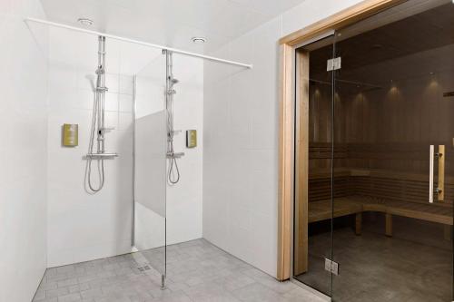 a shower with a glass door in a bathroom at Best Western Plaza Hotel in Eskilstuna