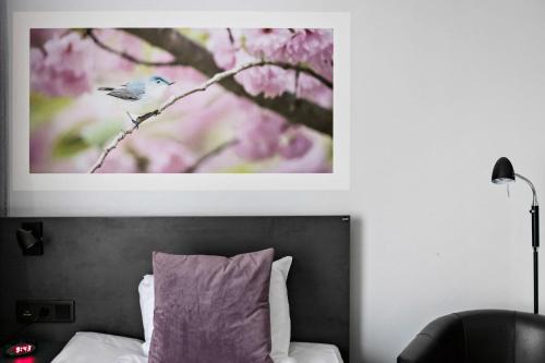 a picture of a bird sitting on a tree branch at Best Western Plaza Hotel in Eskilstuna