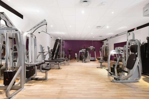 a gym with treadmills and machines in a room at Best Western Plaza Hotel in Eskilstuna