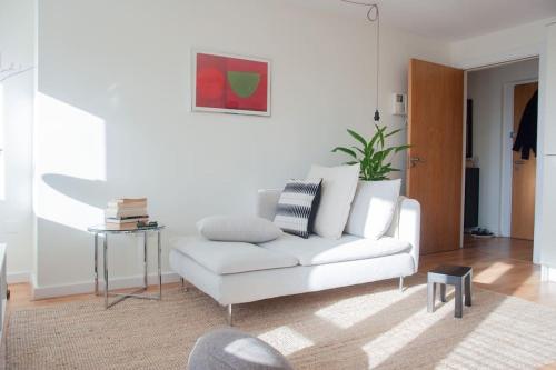 a living room with a white couch and a table at 2 bed 2 bath Apartment with Canal View in Dublin