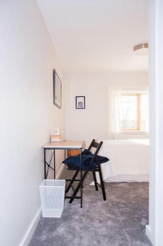a desk and a chair in a room with a tub at 2 bed 2 bath Apartment with Canal View in Dublin