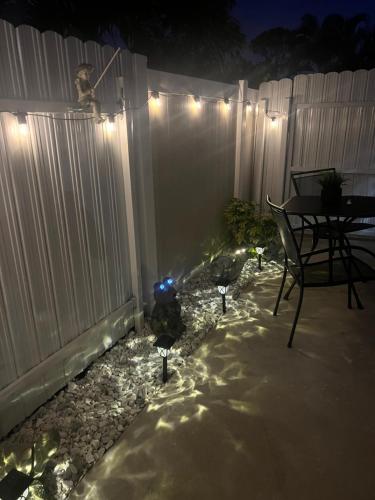 a patio with a table and a fence at night at Villa San Carlos Park in Fort Myers