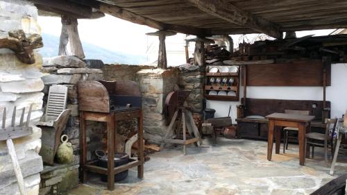 a room with a stone building with a stove at Casa La Fonte in Barcia