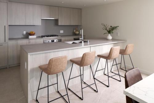 a kitchen with a island with bar stools at Level Seattle Downtown - South Lake Union in Seattle